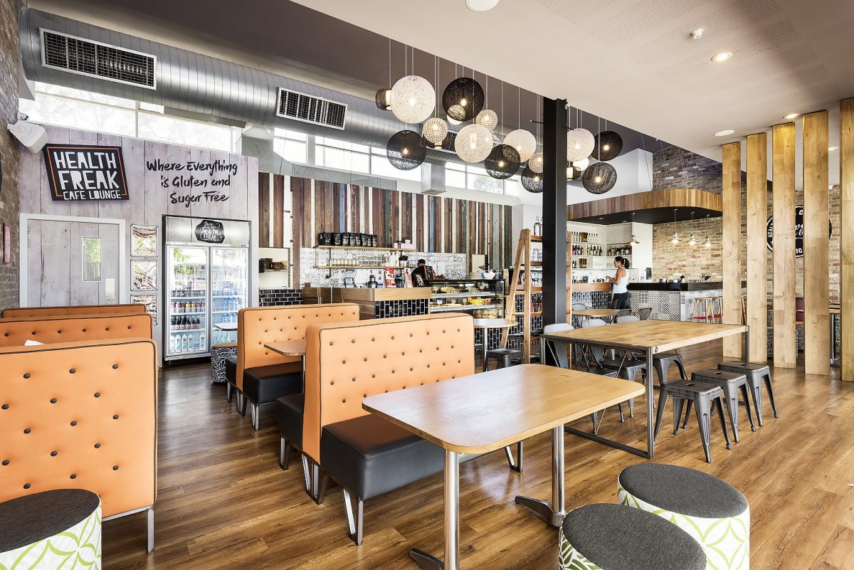 Contemporary cafe design with feature lighting and booth seating