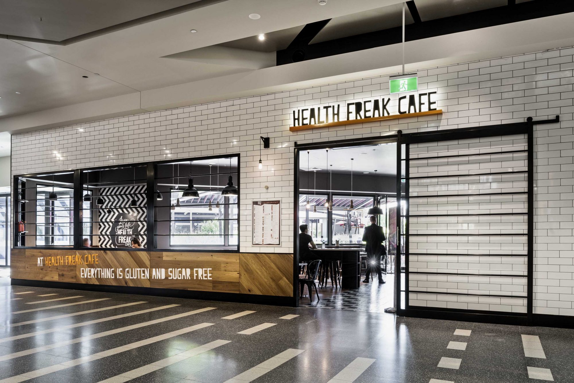 Cafe exterior fitout featuring custom signage and modern finishes