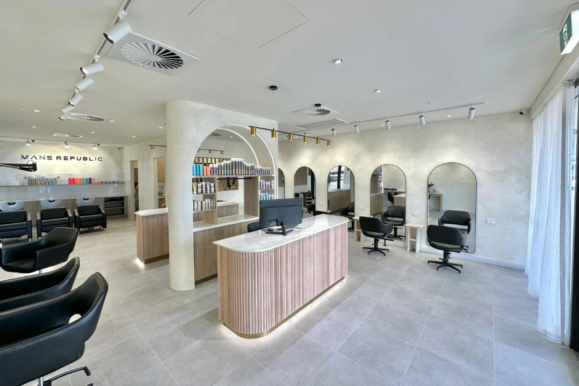 Modern hair salon fitout with feature arches and custom cabinetry